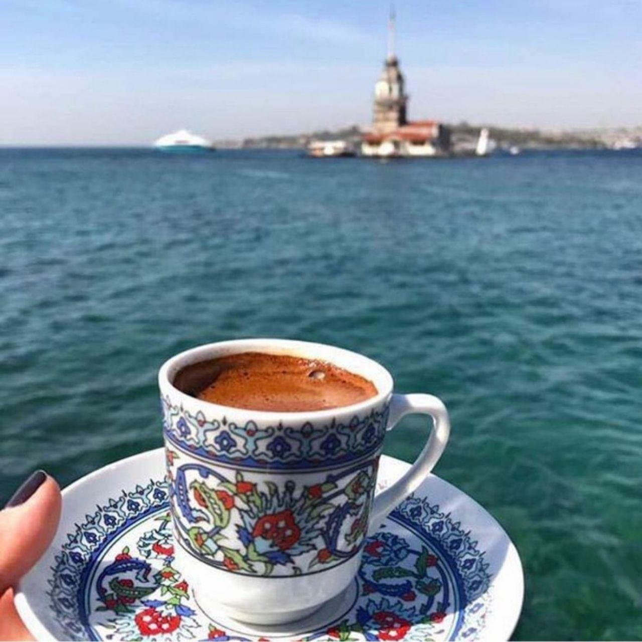 A cup of Turkish coffee with the Maiden's Tower on the Bosphorus behind