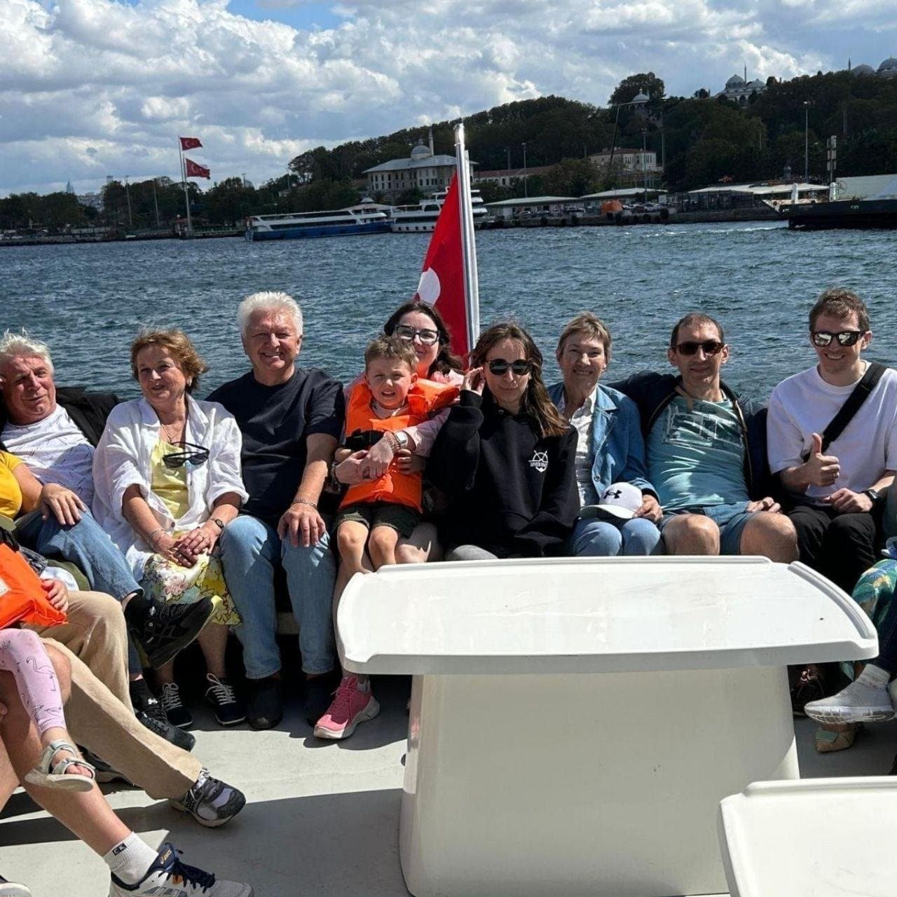 Guests seated on the yacht's foredeck during the cruise