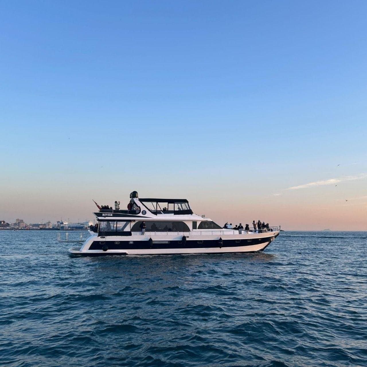 The luxury yacht on the Bosphorus with guests on the open deck