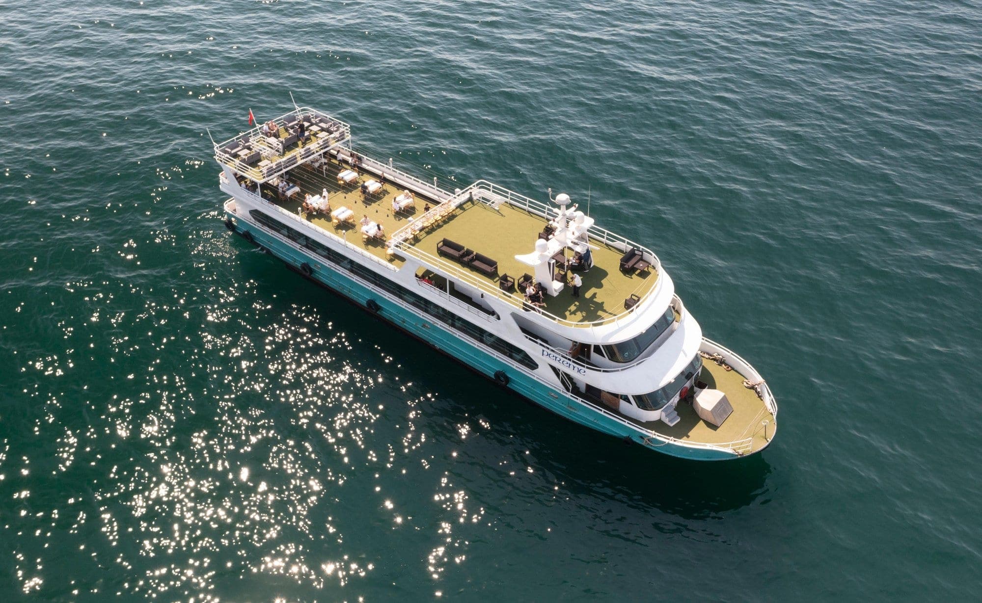 Aerial view of the Pereme tour boat with open-deck seating on the sunlit Bosphorus