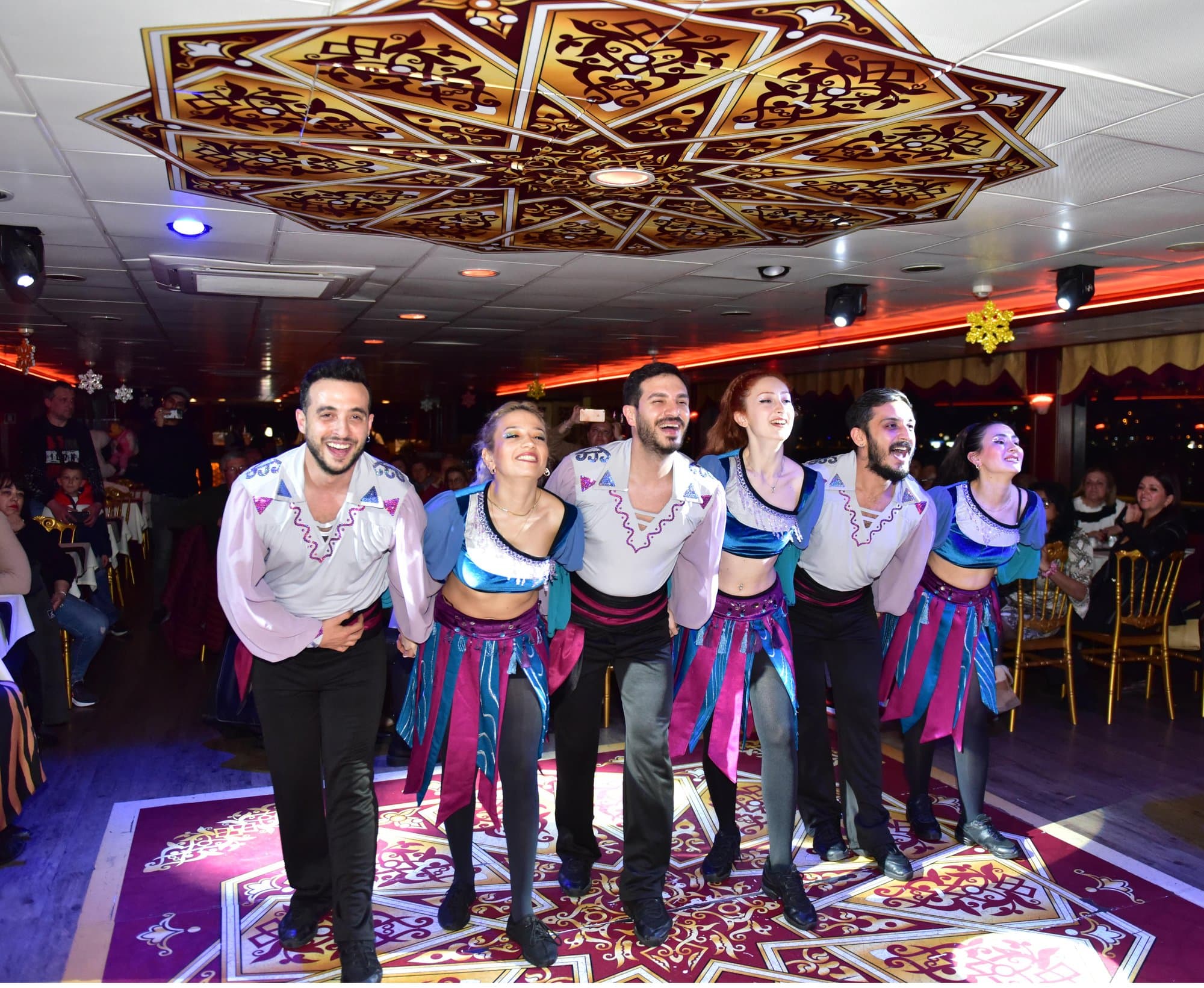 A folk dance group performing on the cruise dance floor