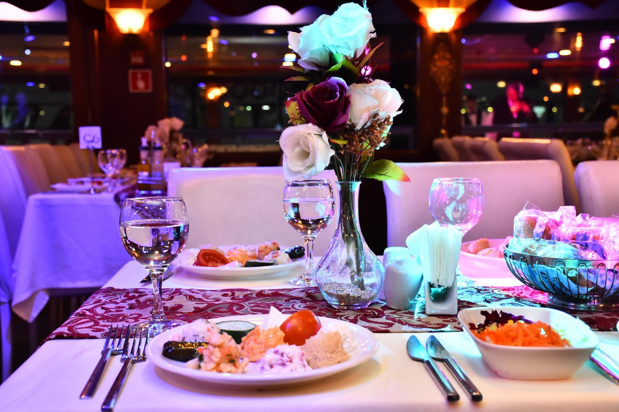 A dinner table on the cruise set with Turkish appetizers, salad and drinks