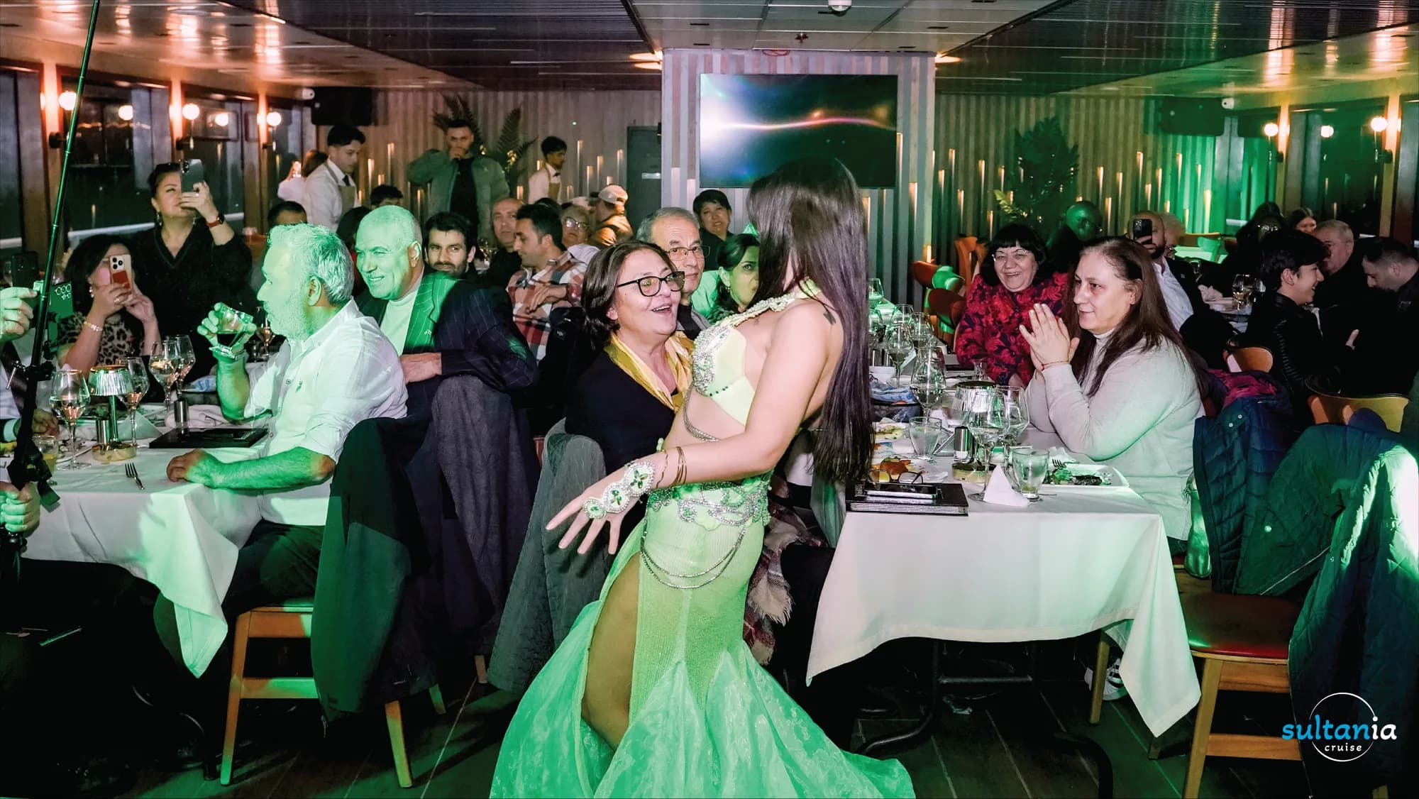 A belly dancer performing among the guest tables during the Turkish night show