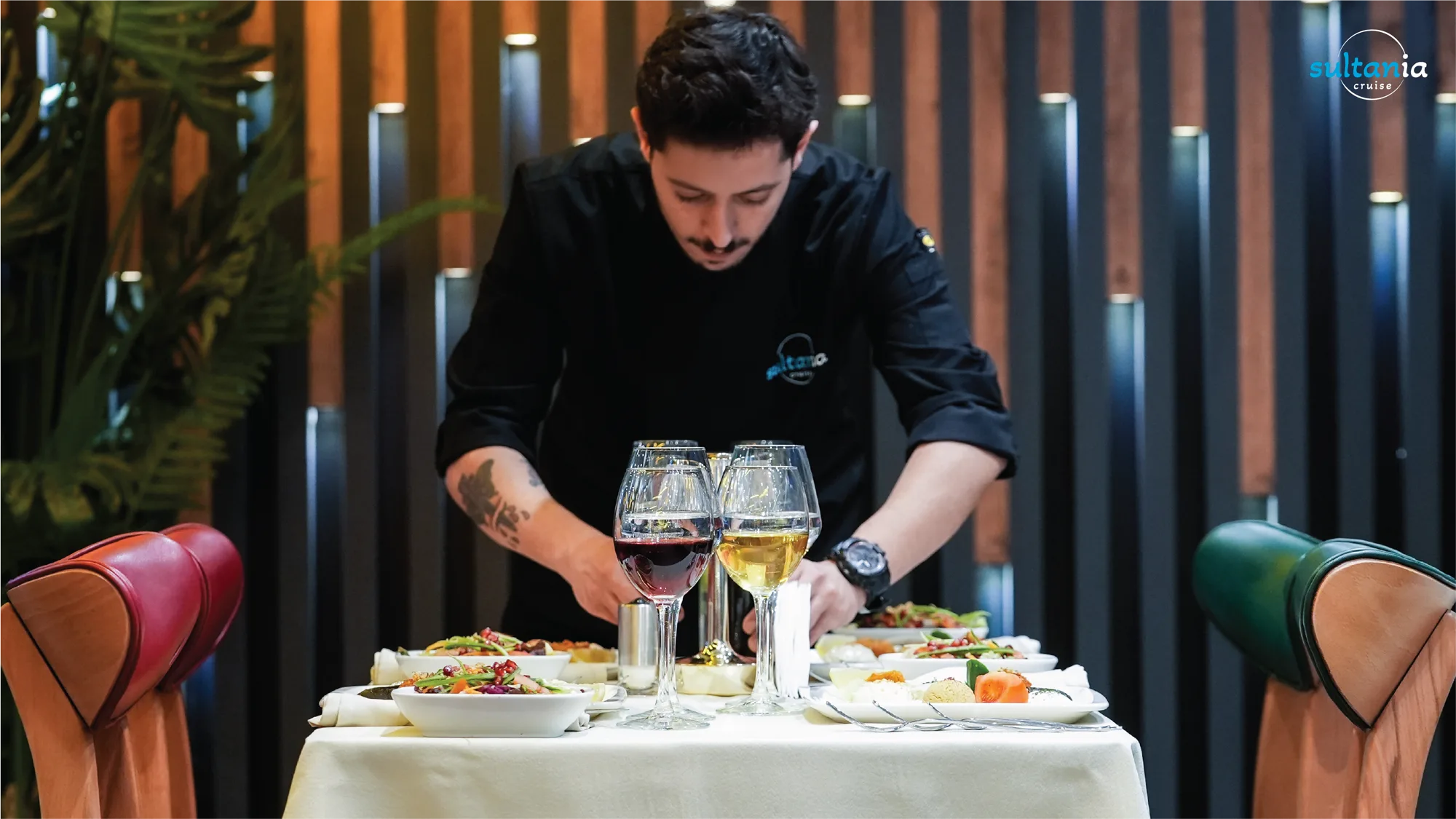 The chef plating a table of Turkish appetizers and wine on the boat