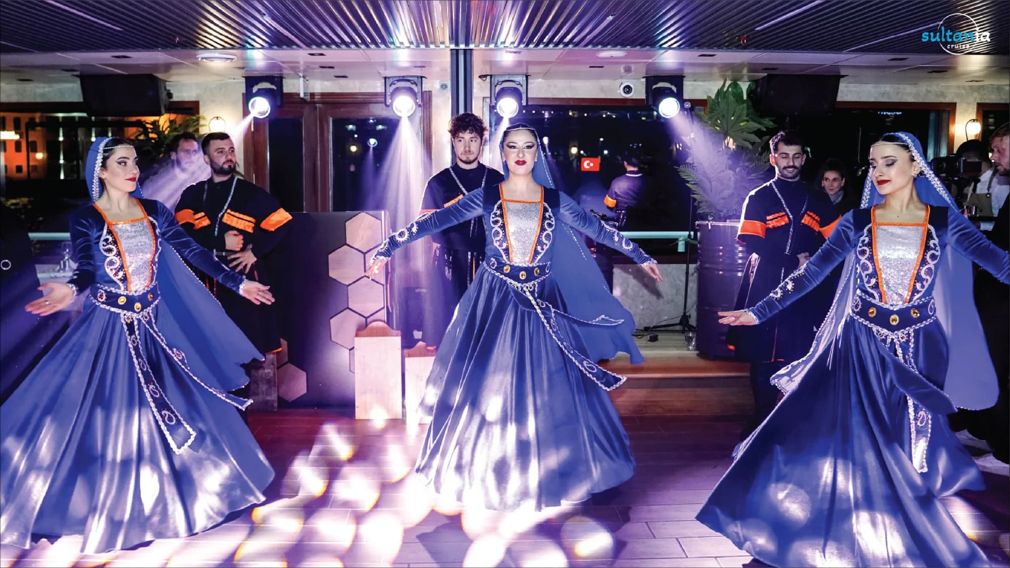 A Turkish folk dance troupe performing in traditional costume on the boat