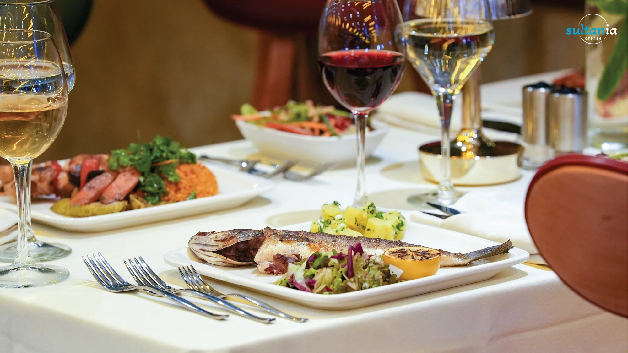 A grilled fish main course with potatoes and salad on the dinner cruise