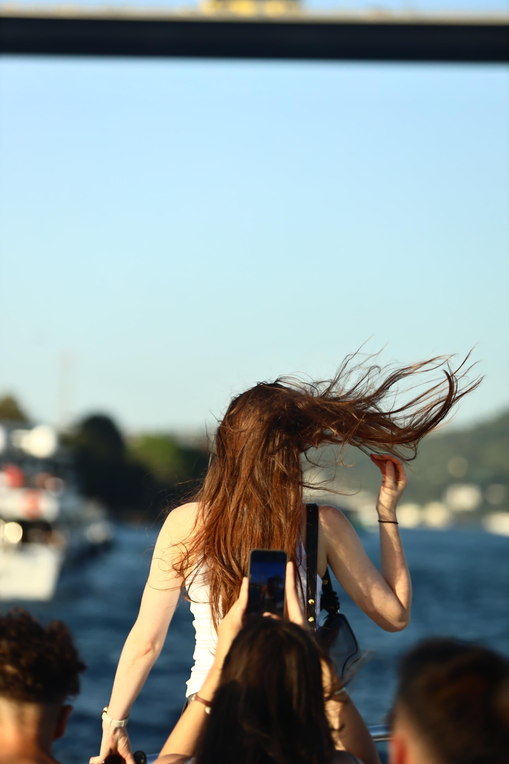 A guest taking a photo of the Bosphorus from the yacht deck