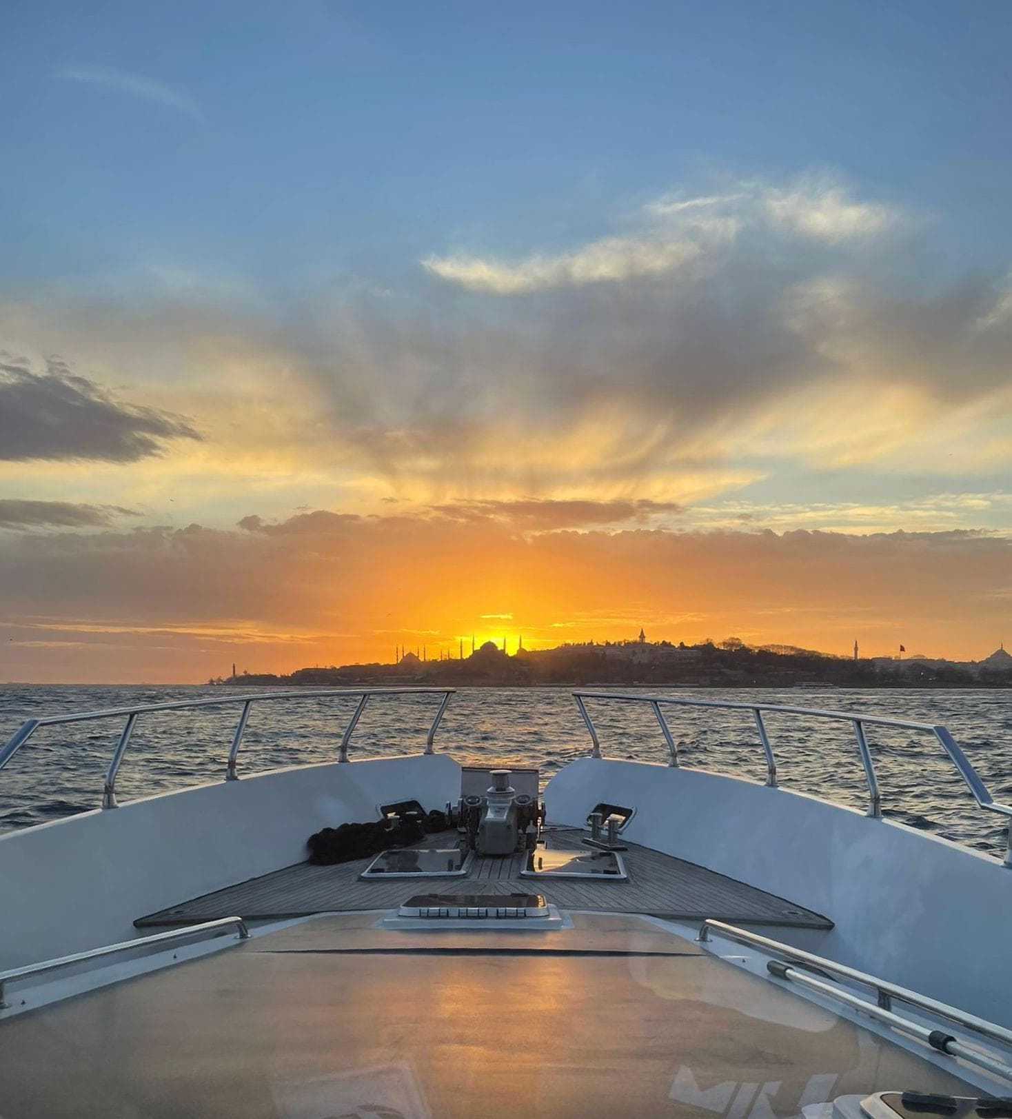 View from the bow toward the sunset over Istanbul's old-city skyline