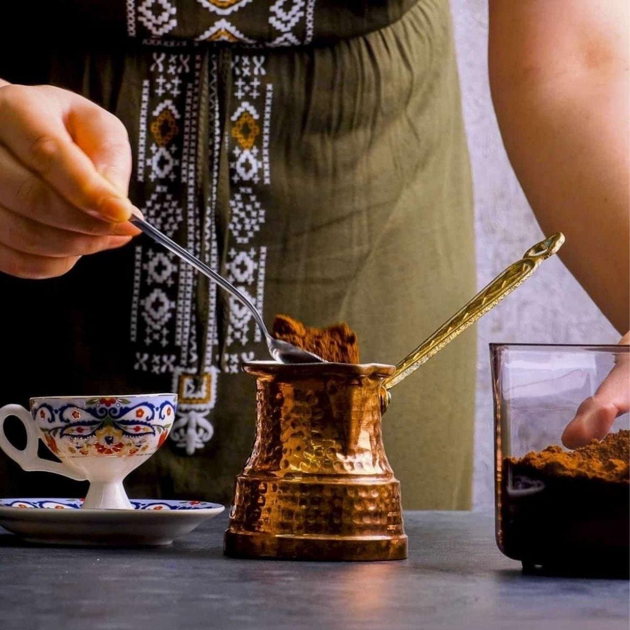 Turkish coffee being prepared in a traditional copper cezve