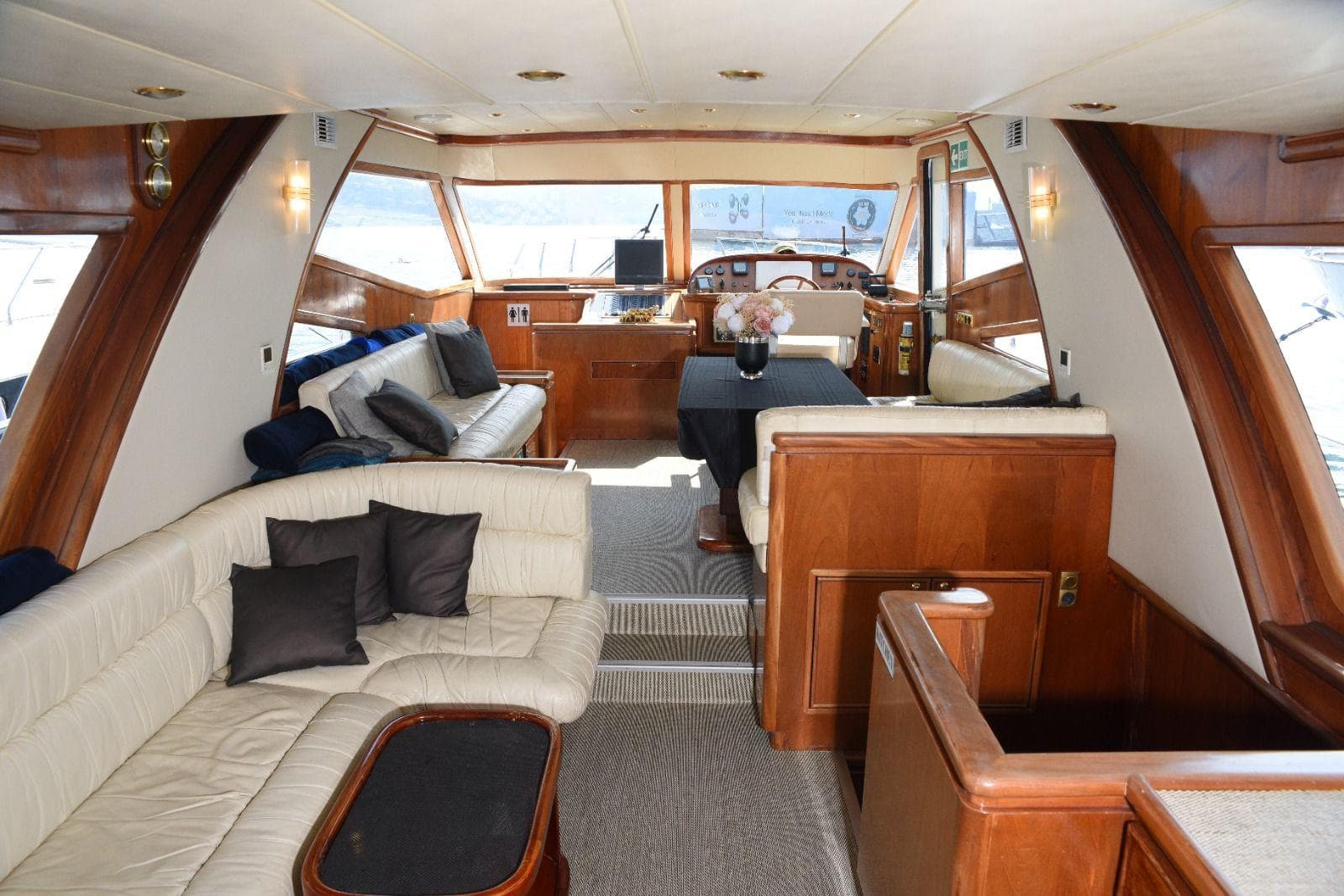 The yacht's wood-panelled indoor saloon with leather sofas